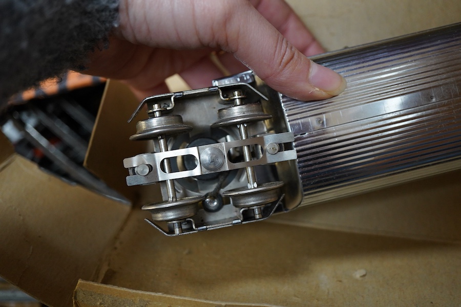 A boxed Lionel 0 gauge ‘Flying Yankee’ train set, comprising of a streamlined articulated diesel locomotive No.616, and three articulated chrome bogie cars; two No.617 and an observation car No.618, together with a boxed